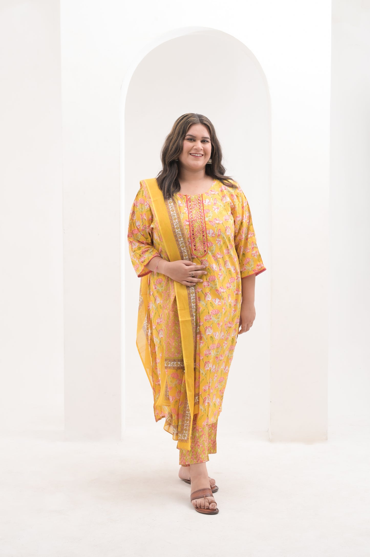 yellow with pink highlights, mirror work on net, cotton floral print  suit set