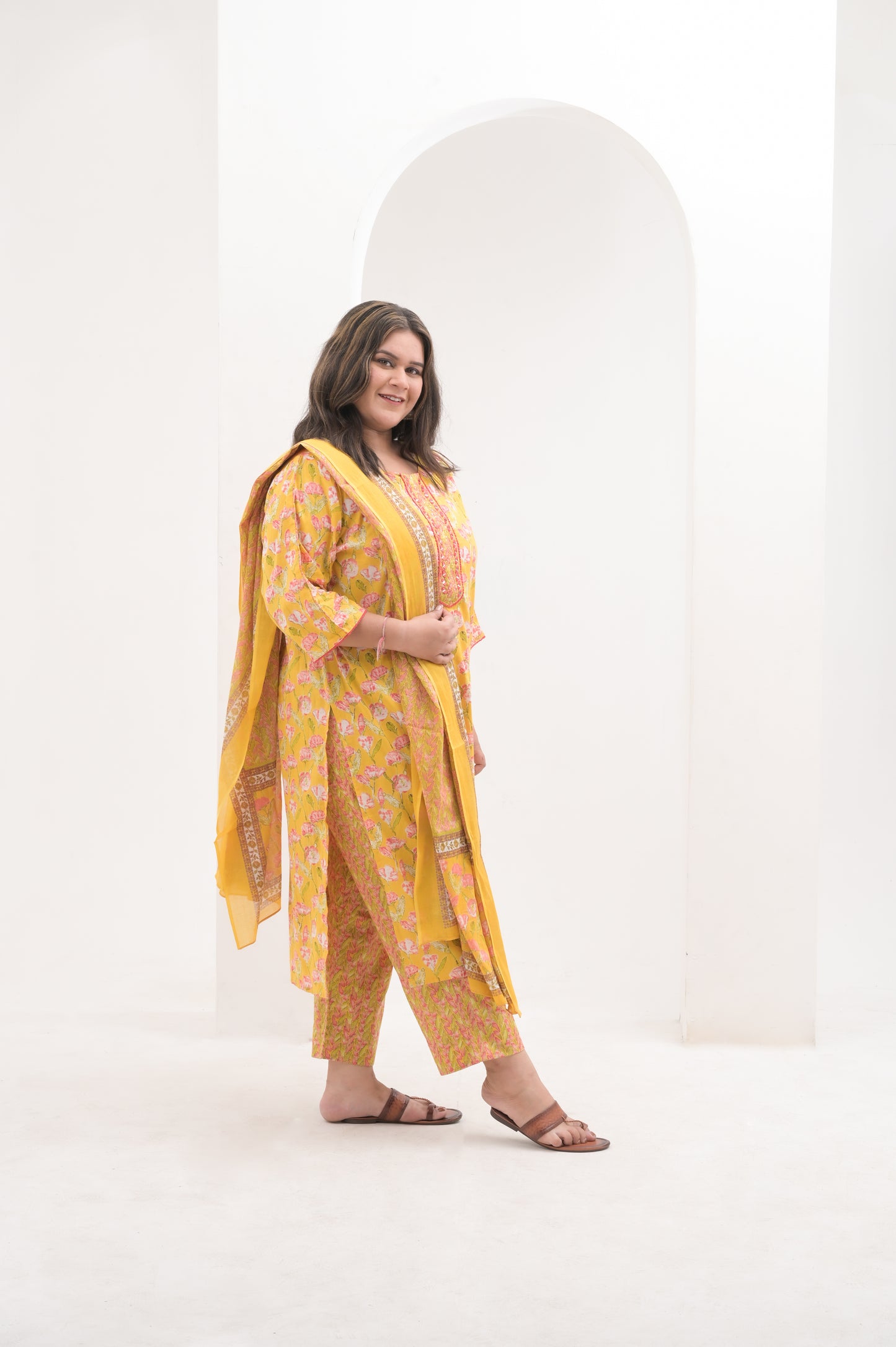 yellow with pink highlights, mirror work on net, cotton floral print  suit set