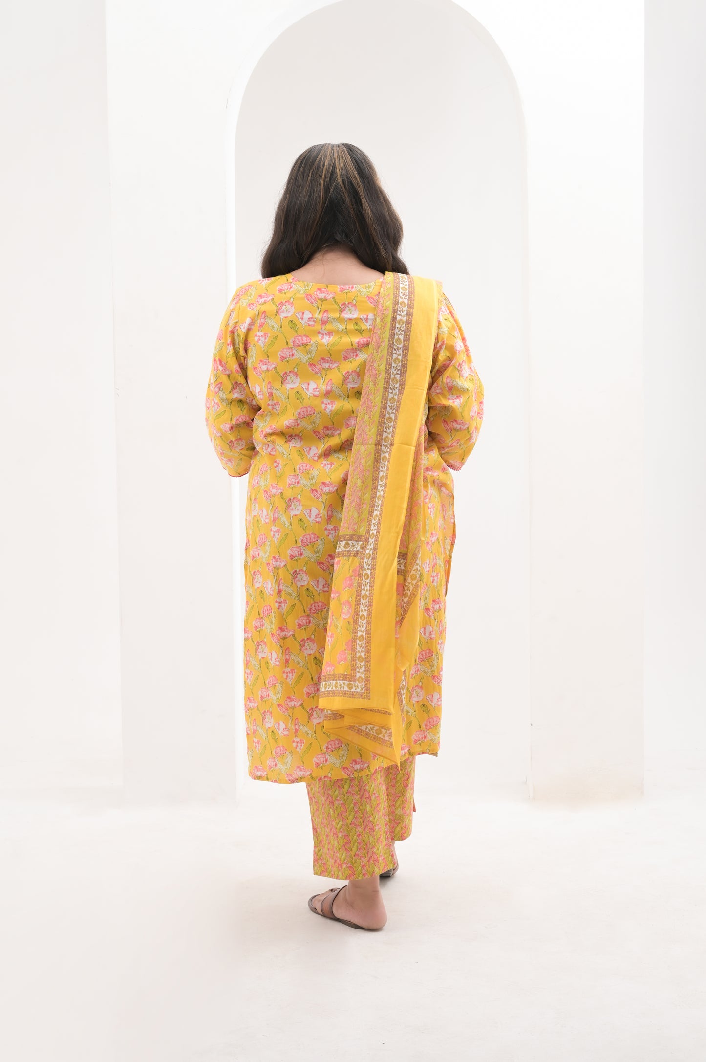 yellow with pink highlights, mirror work on net, cotton floral print  suit set