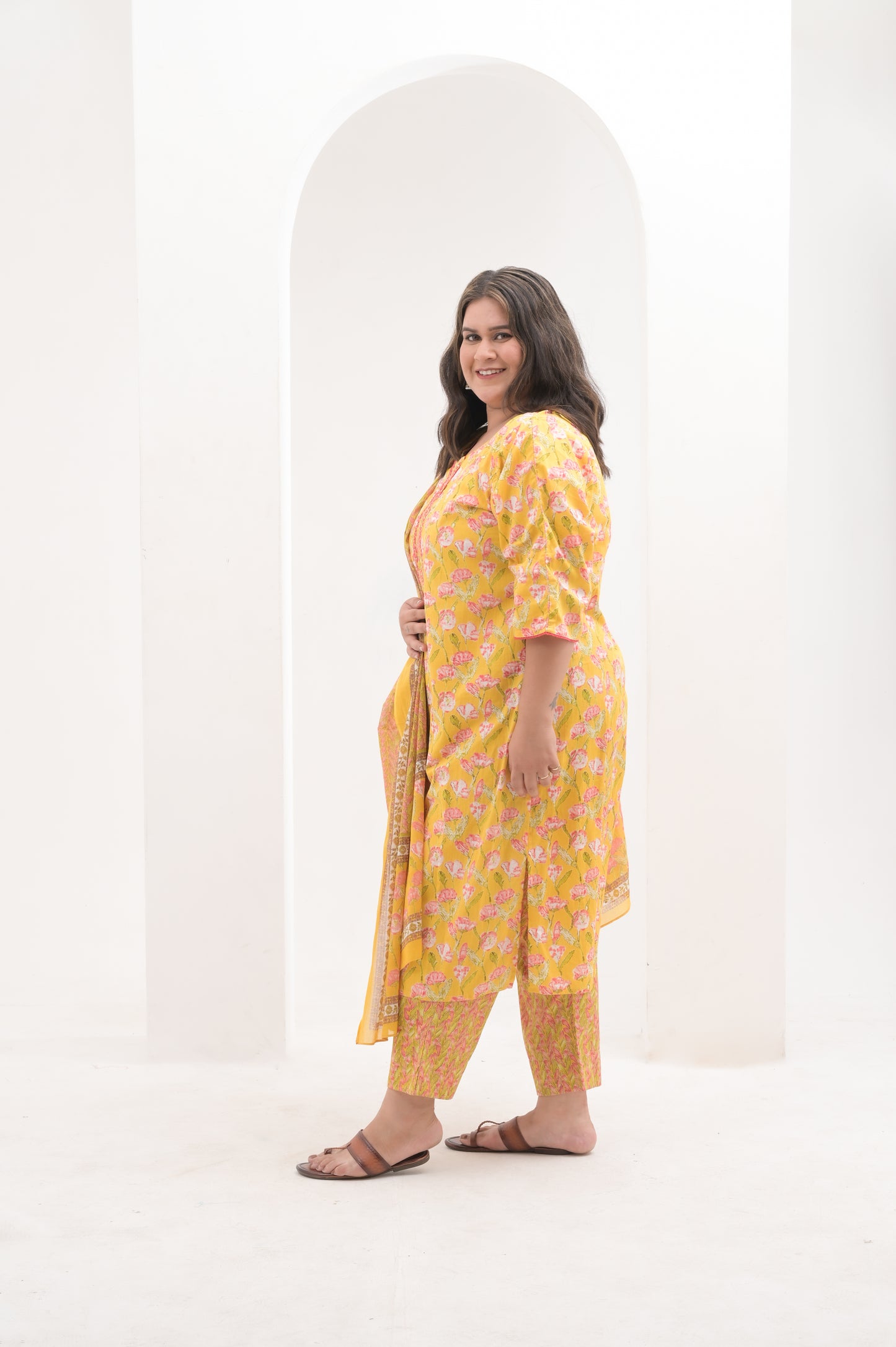 yellow with pink highlights, mirror work on net, cotton floral print  suit set