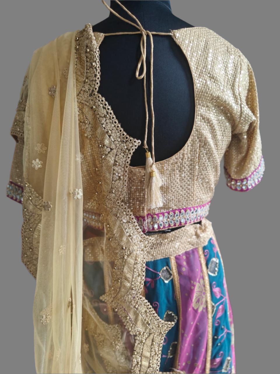 blue-pink lehnga with golden embroidered blouse and net dupatta